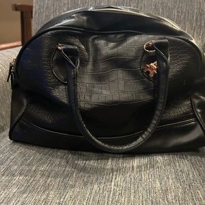 black leather bag with Effiel tower keychain